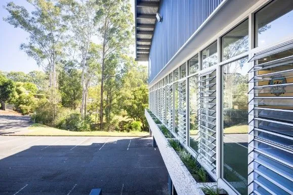 Commercial aluminium framing with a long run of louvre and fixed windows