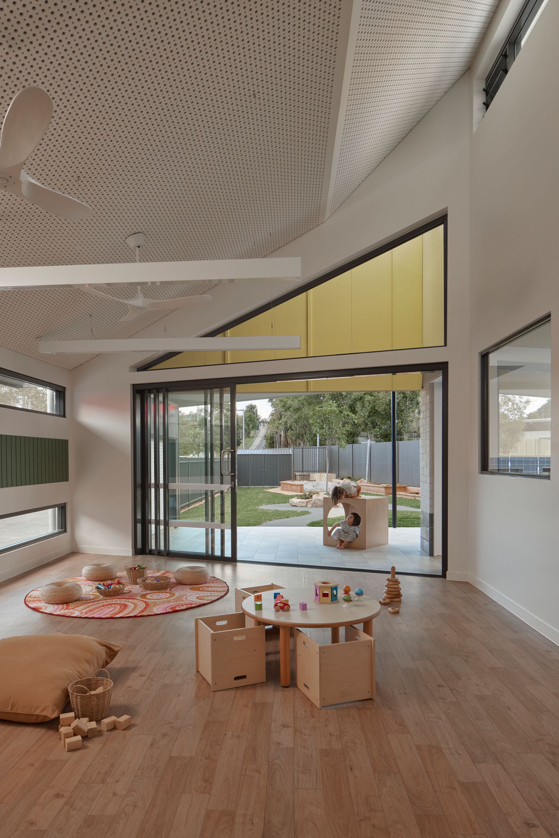 Tall childcare interior with commercial aluminium framing and glass doors by AGS
