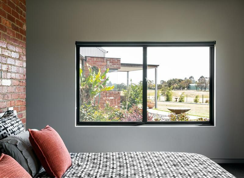Black aluminium sliding window manufactured by AGS for a Sunshine Coast home